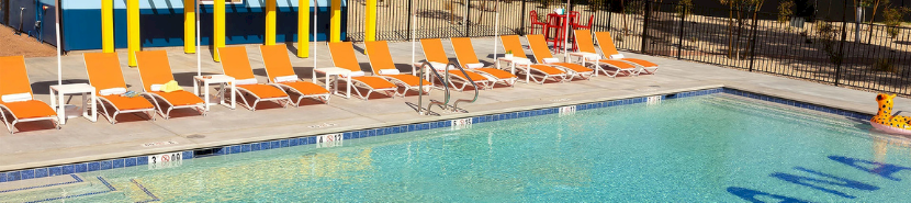 a pool with chairs and umbrellas