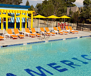 a pool with chairs and umbrellas