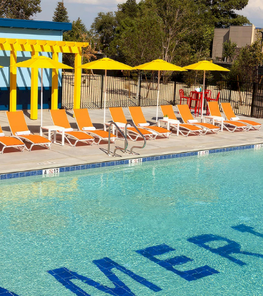 a pool with chairs and umbrellas