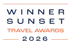 The image shows the words &ldquo;WINNER SUNSET TRAVEL AWARDS 2028,&rdquo; with a blue &ldquo;WINNER&rdquo; and &ldquo;SUNSET&rdquo; and orange dividers.